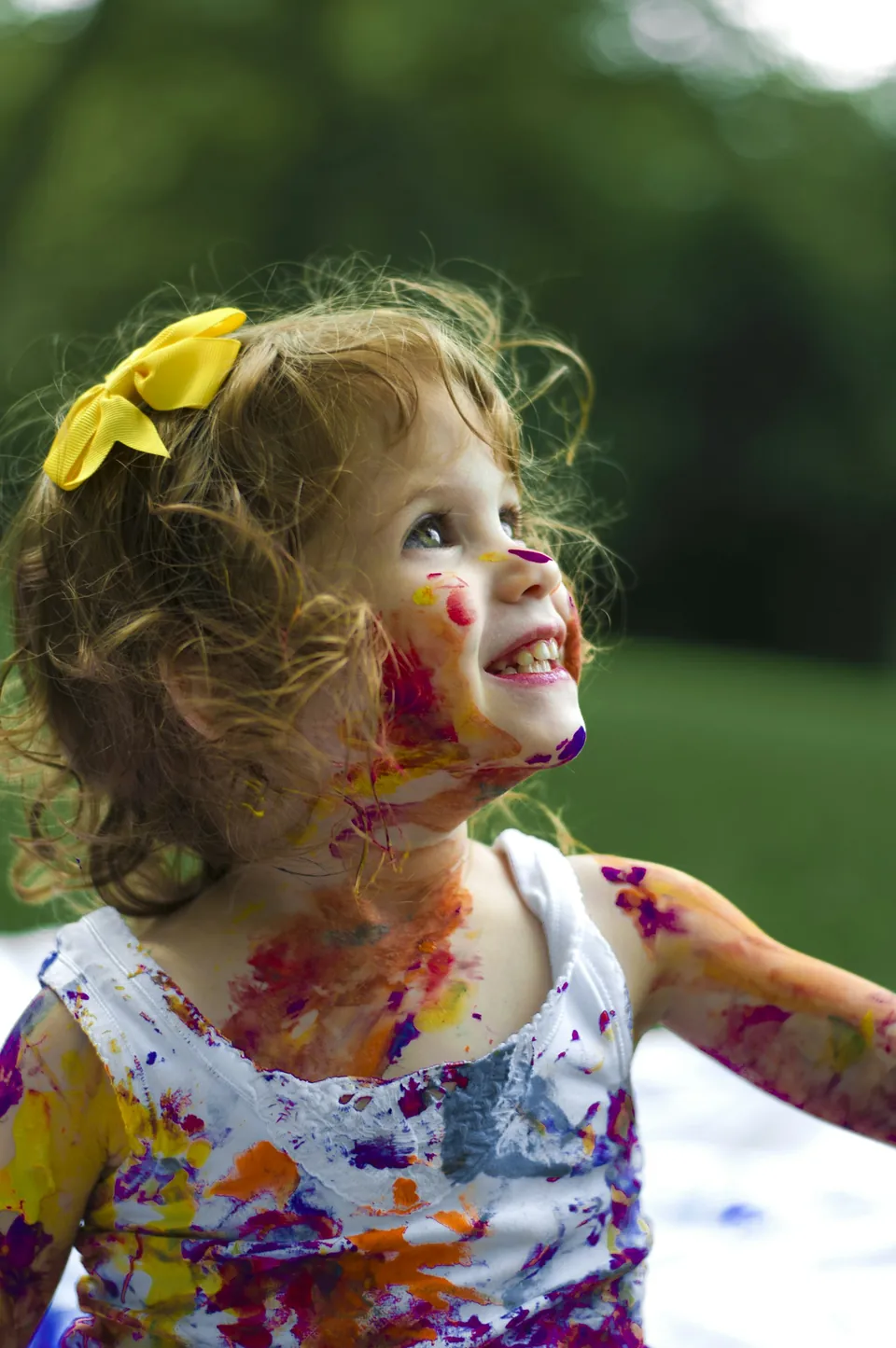 Criança com pintura colorida no rosto ao ar livre